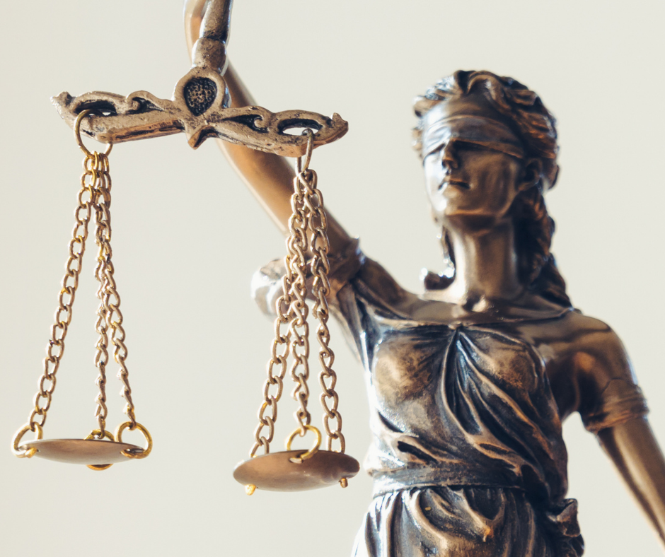 Stock photo of a small statue of a blinfolded lady justice